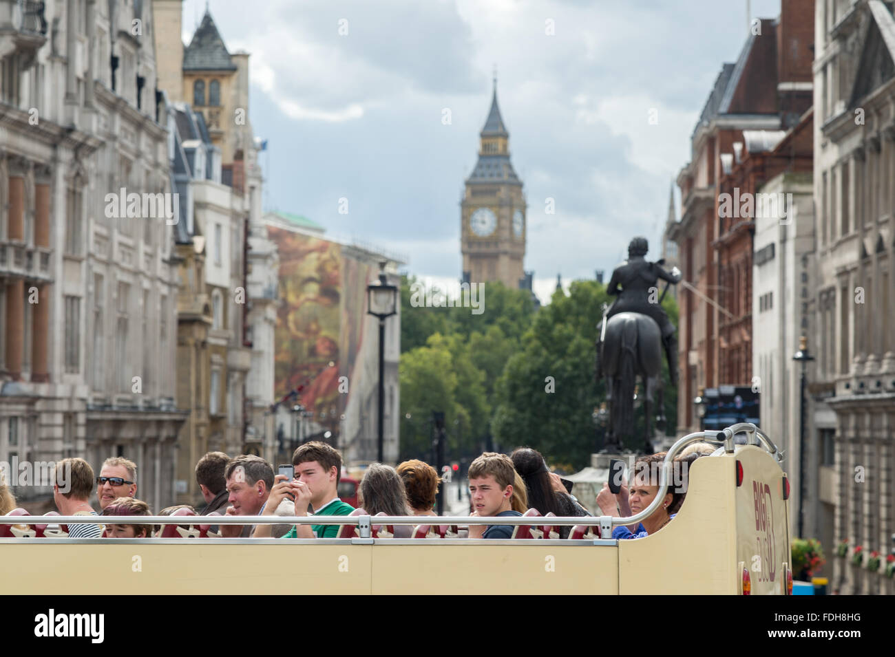 Tourists on a double decker bus in front of Big Ben in London, England. Stock Photo