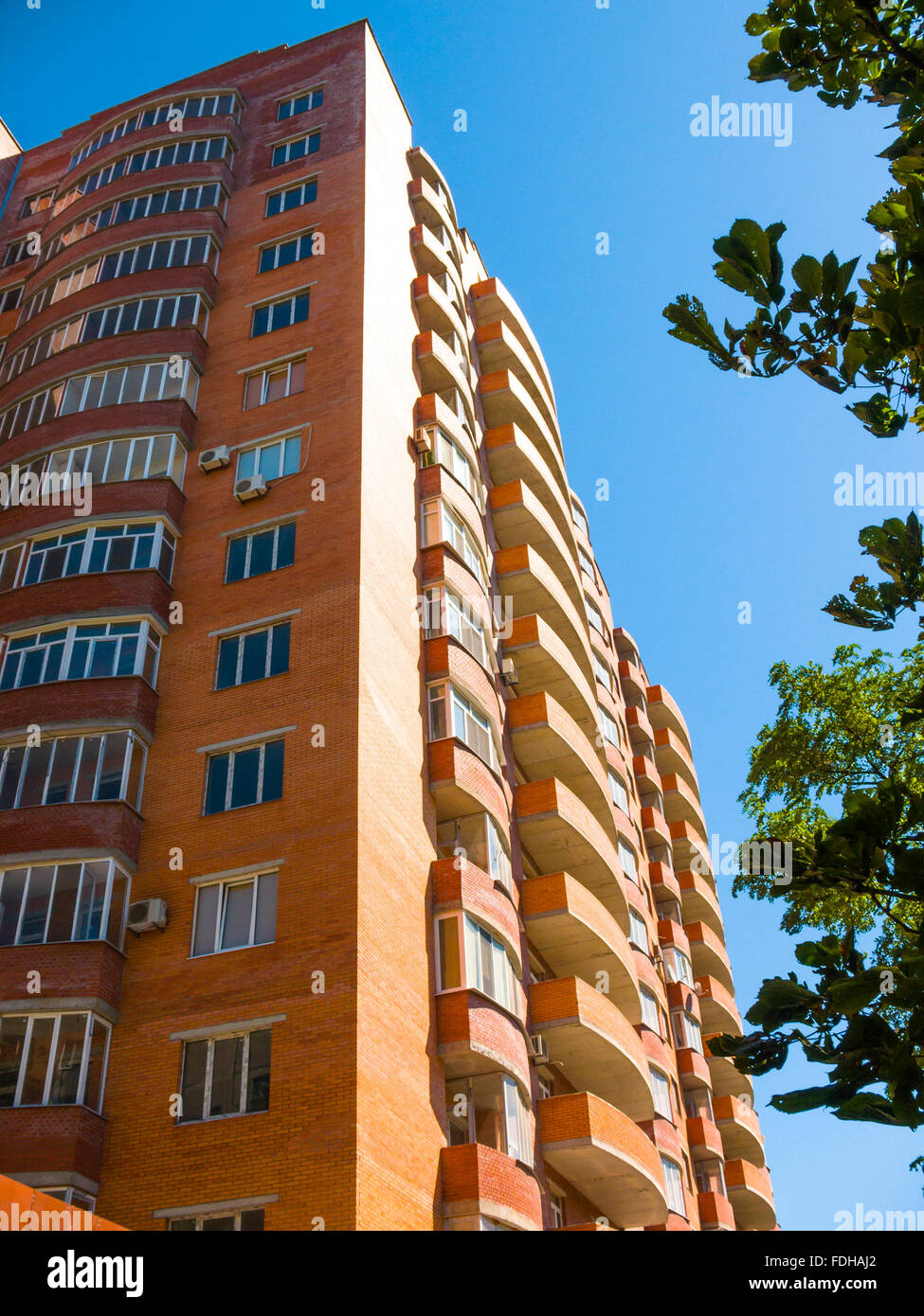 high residential house on blue sky background with trees Stock Photo ...