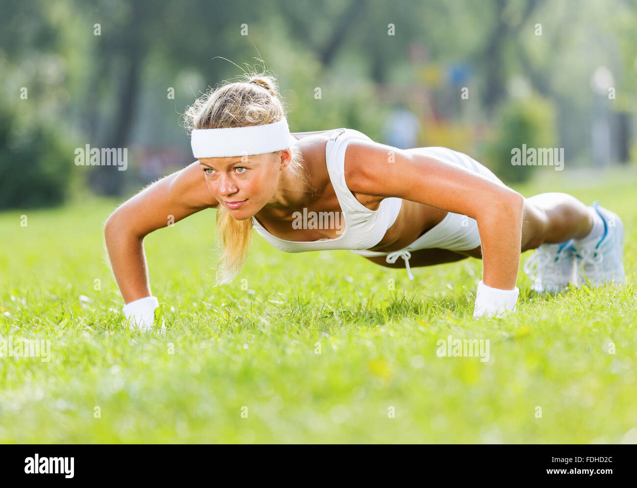 Young attractive sport girl in park doing push ups Stock Photo - Alamy