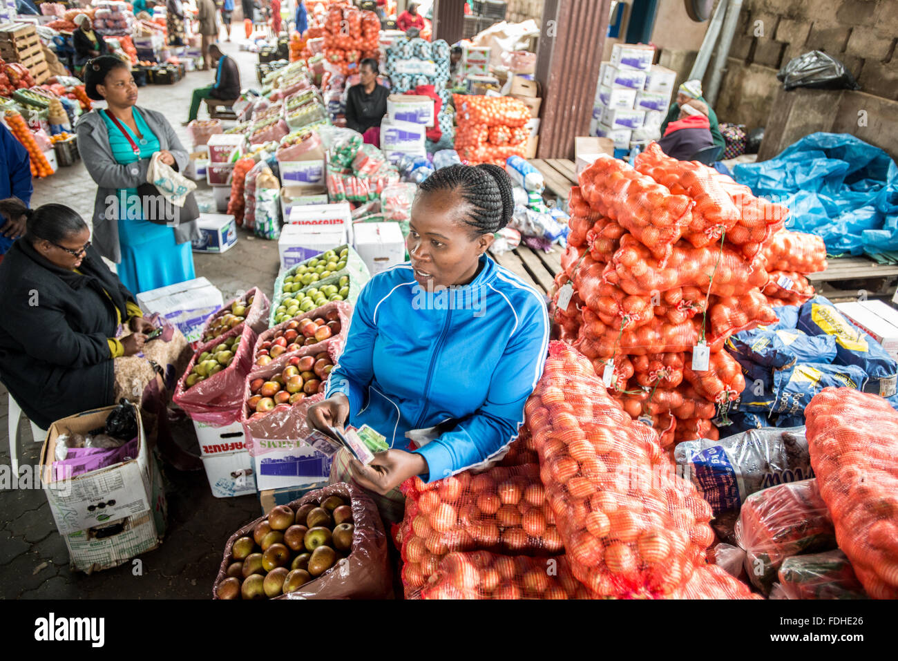 Woman selling produce at the Manzini Wholesale Produce and Craft Market in Swaziland, Africa. Stock Photo
