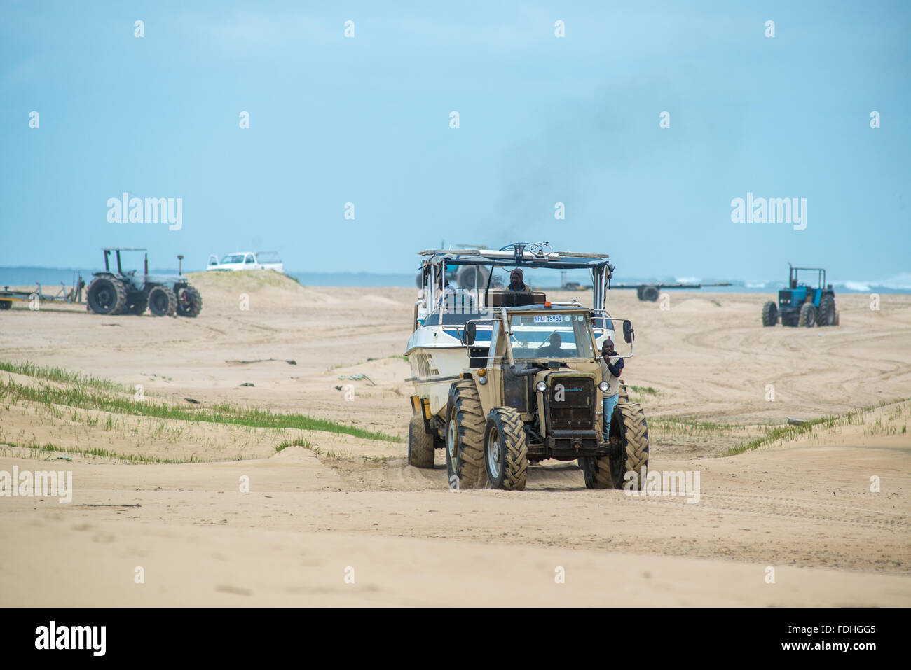 Tractor towing a boat on the beach in Saint Lucia, Kwazulu-Natal, South Africa - iSimangaliso Wetland Park Stock Photo