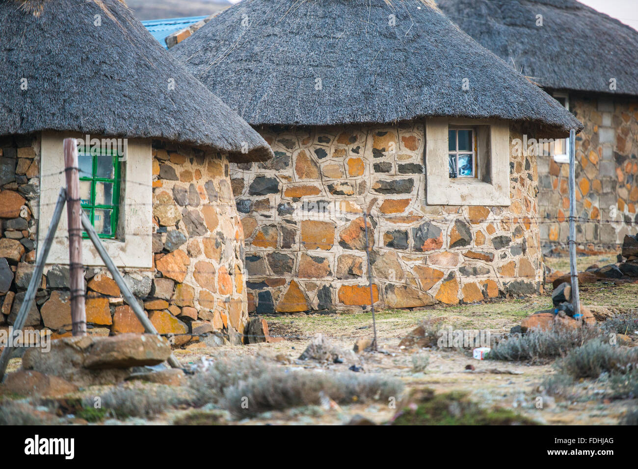 Row of village huts surrounded by fencing in Sani Pass, Lesotho, Africa. Stock Photo