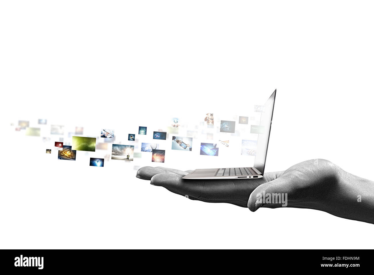 Close up of hand with laptop and media icons Stock Photo - Alamy