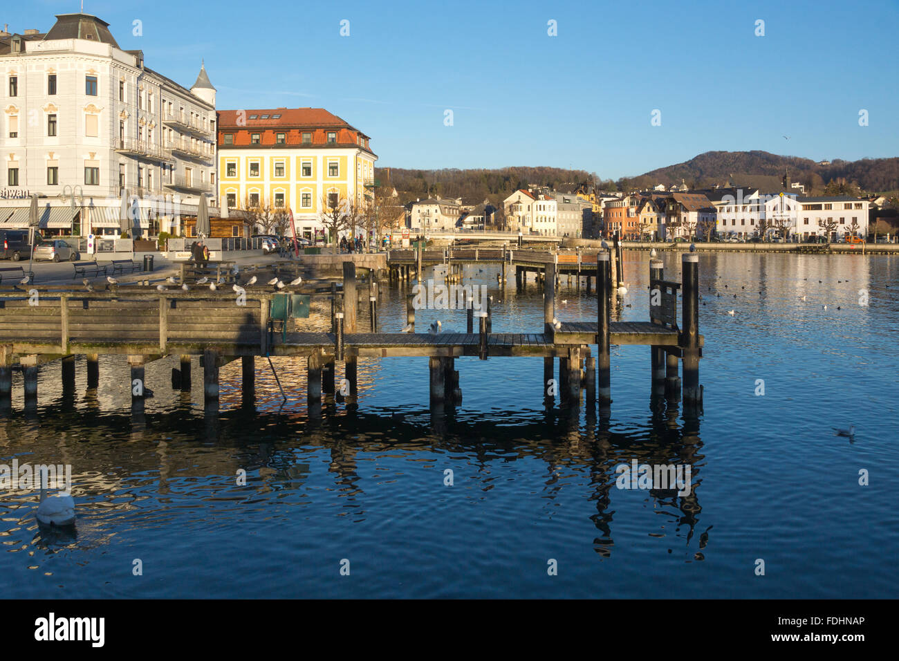 A view of the jetties and people walking in the winter sunshine in Gmunden, Upper Austria Stock Photo