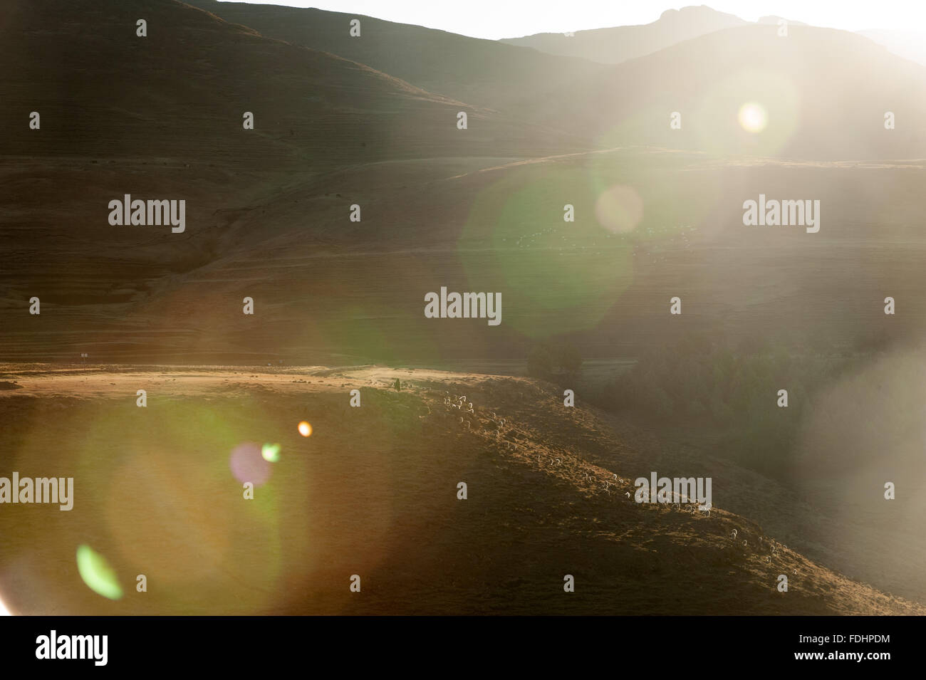 Landscape of mountains with a sun flare in Lesotho, Africa Stock Photo