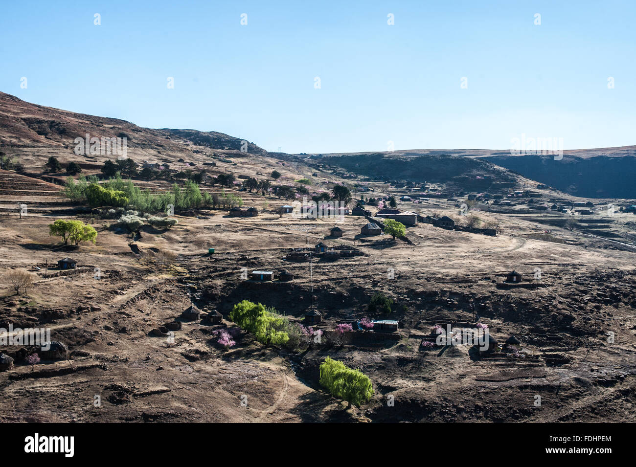 Landscape with village huts and mountaintops in Lesotho, Africa Stock Photo
