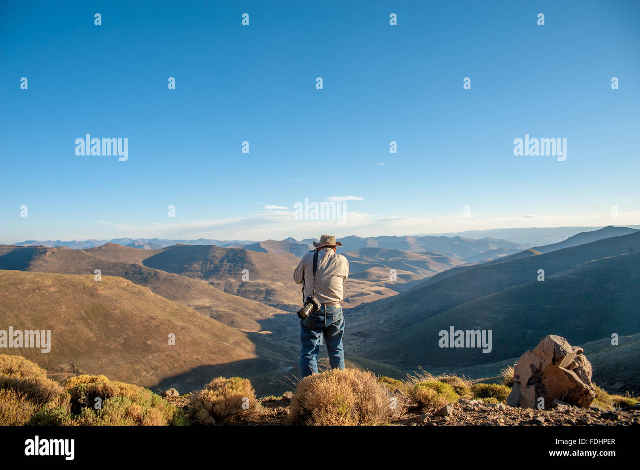Tourist photographing the landscape of mountains in Lesotho, Africa Stock Photo