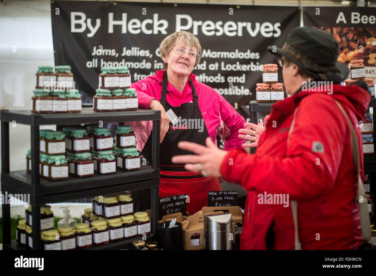Woman selling homemade preserves at the market at the International Sheepdog Trials in Moffat, Scotland, UK. Stock Photo