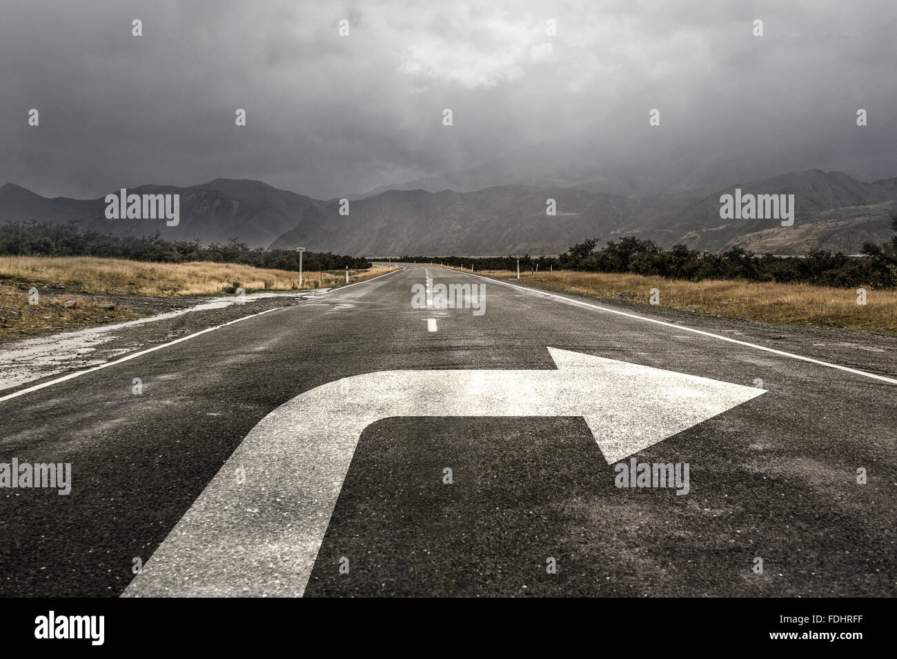 Natural landscape of asphalt road and drawn turn arrow Stock Photo - Alamy