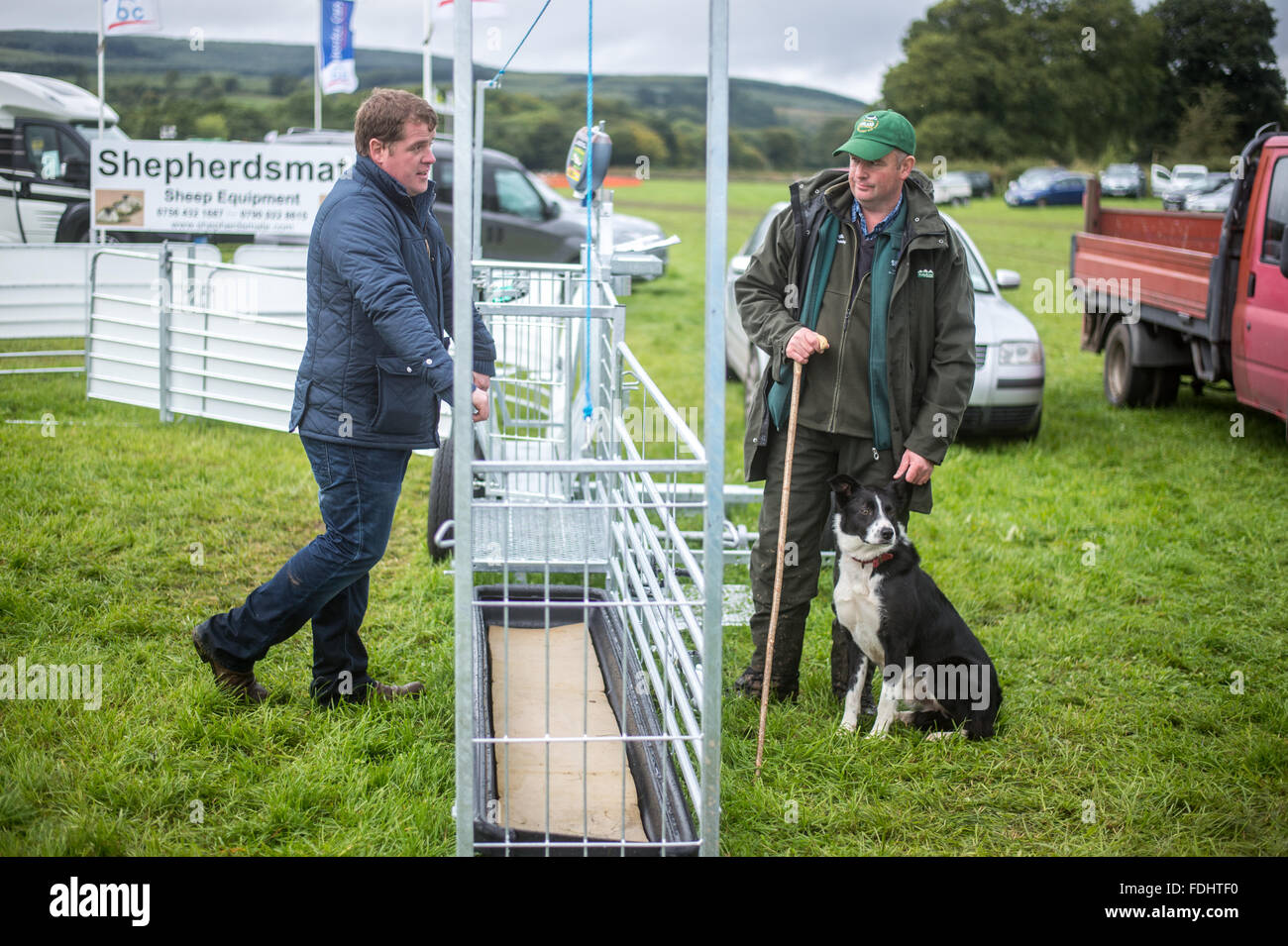 Border collie and its Shepherd at the International Sheep Dog Trials in Moffat, Scotland, UK. Stock Photo