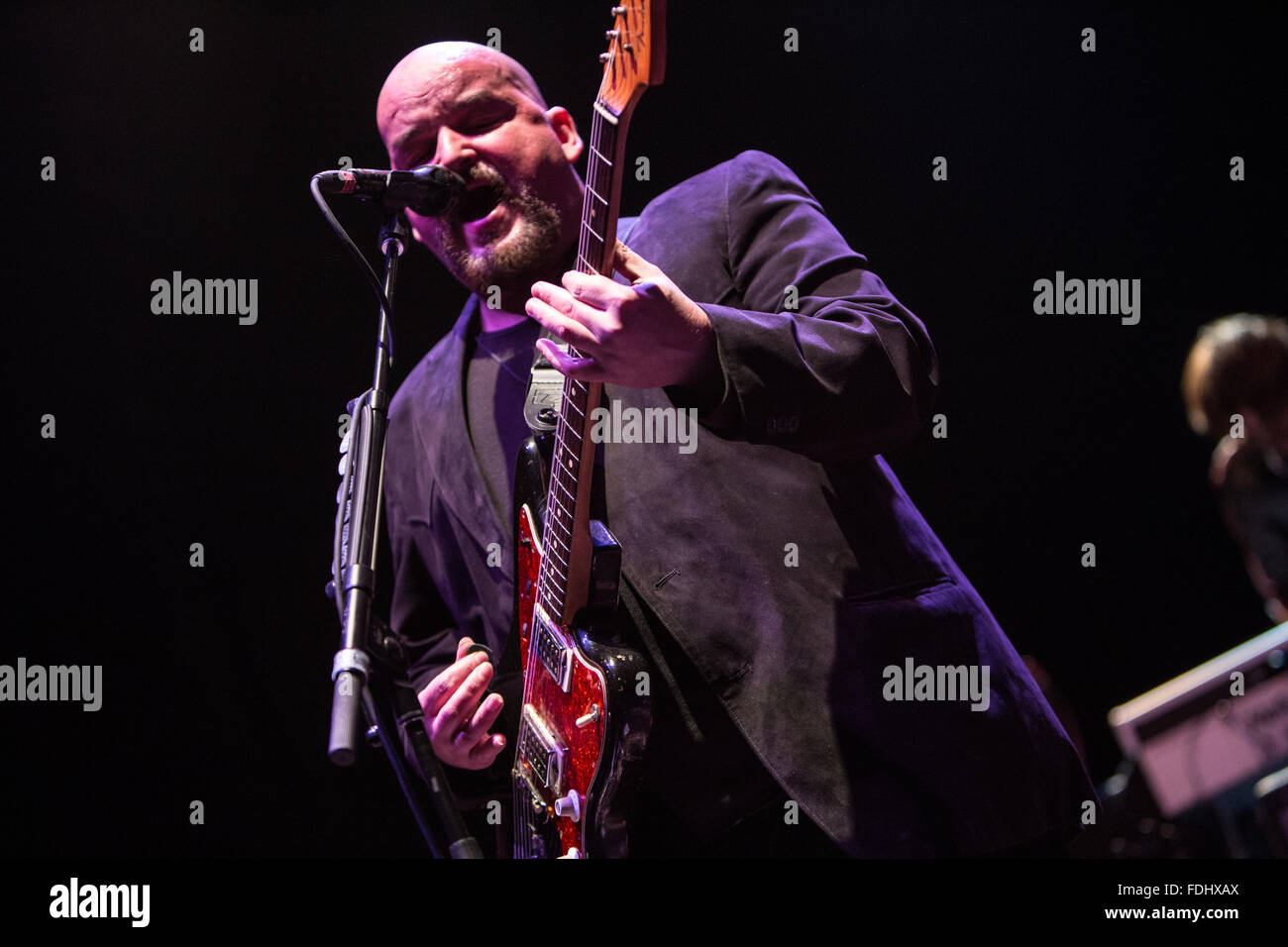 Alain Johannes singing and playing guitar Stock Photo