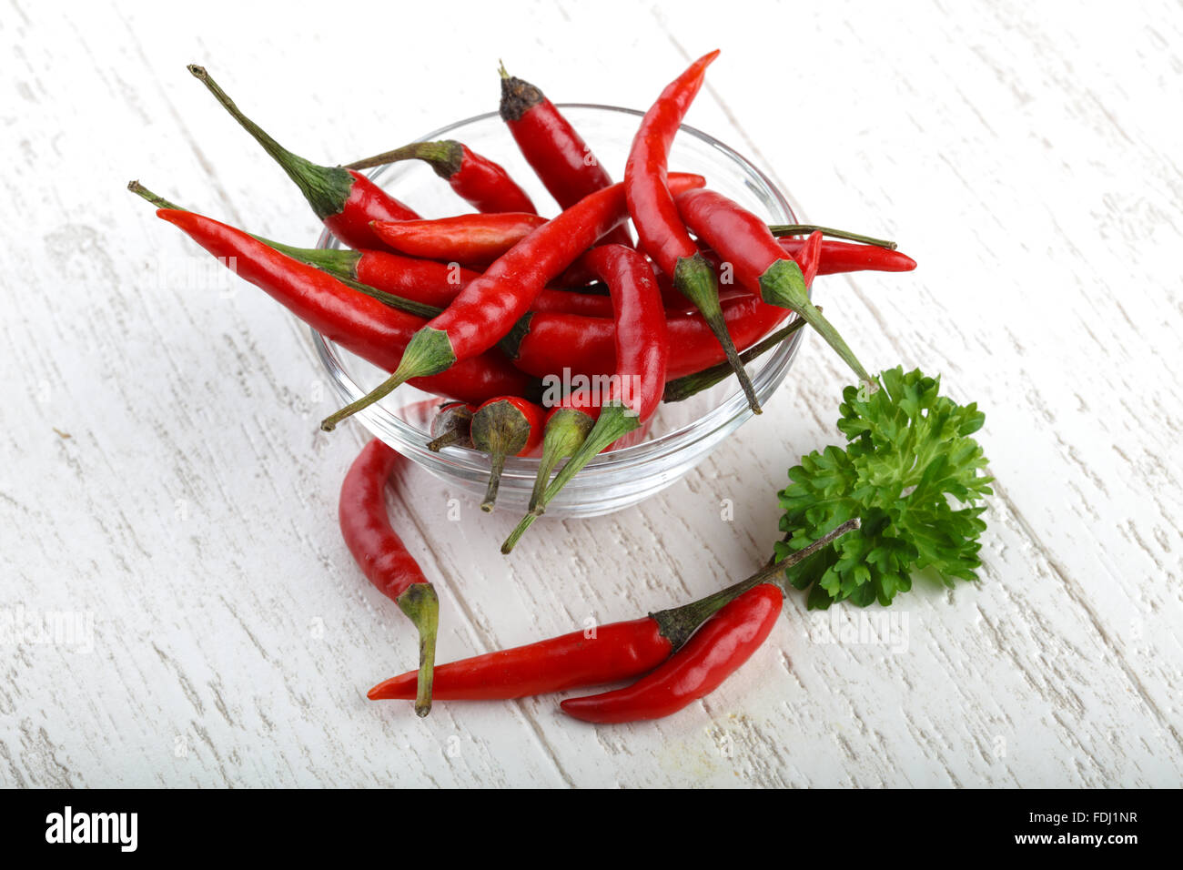 Red hot chili peppers heap on the wood background Stock Photo - Alamy