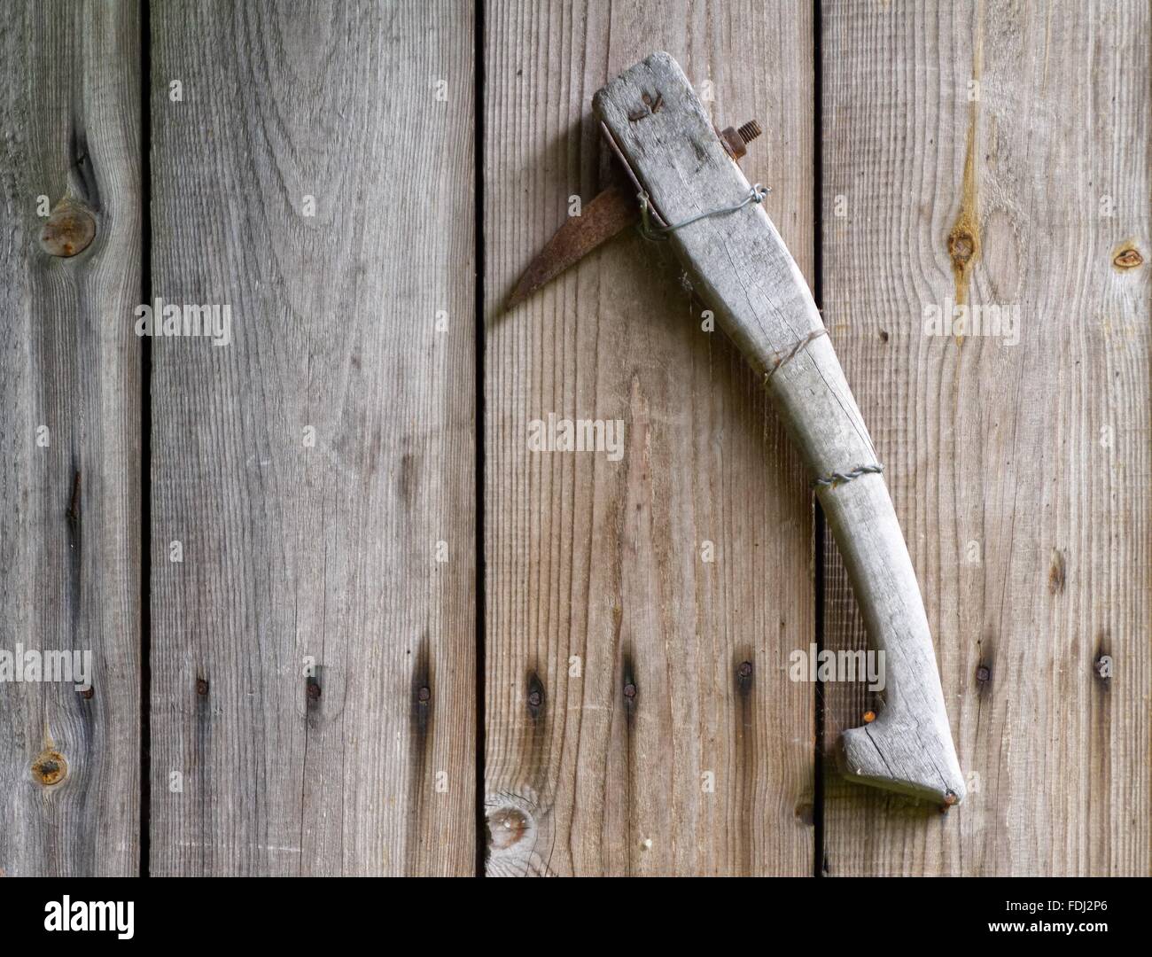 Anciet rusty axe on plank wall. Vintage detail on countryside scene. Stock Photo