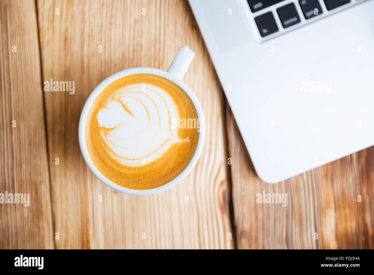 Top view of a cup with cappucino on the wooden table Stock Photo - Alamy
