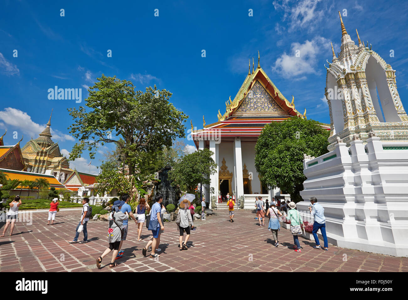 Tourists walking in the Wat Pho Temple. Bangkok, Thailand. Stock Photo