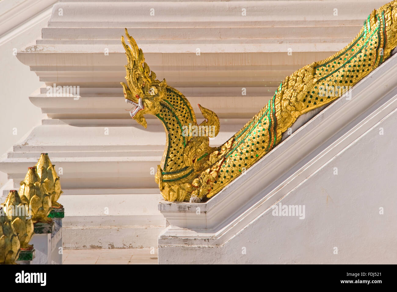 A golden Naga on steps in Luang Prabang, Laos Stock Photo