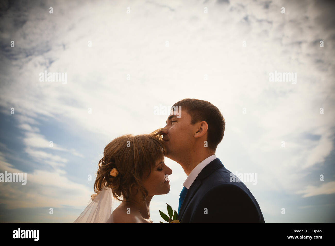 young bride and groom on the background sky Stock Photo - Alamy