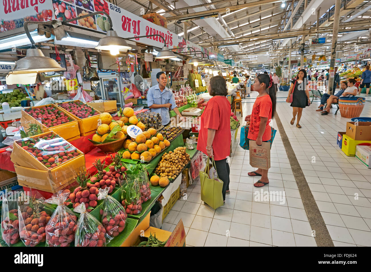 Shoppers at the fruit stall at Or Tor Kor (OTK) Fresh Market. Bangkok, Thailand. Stock Photo