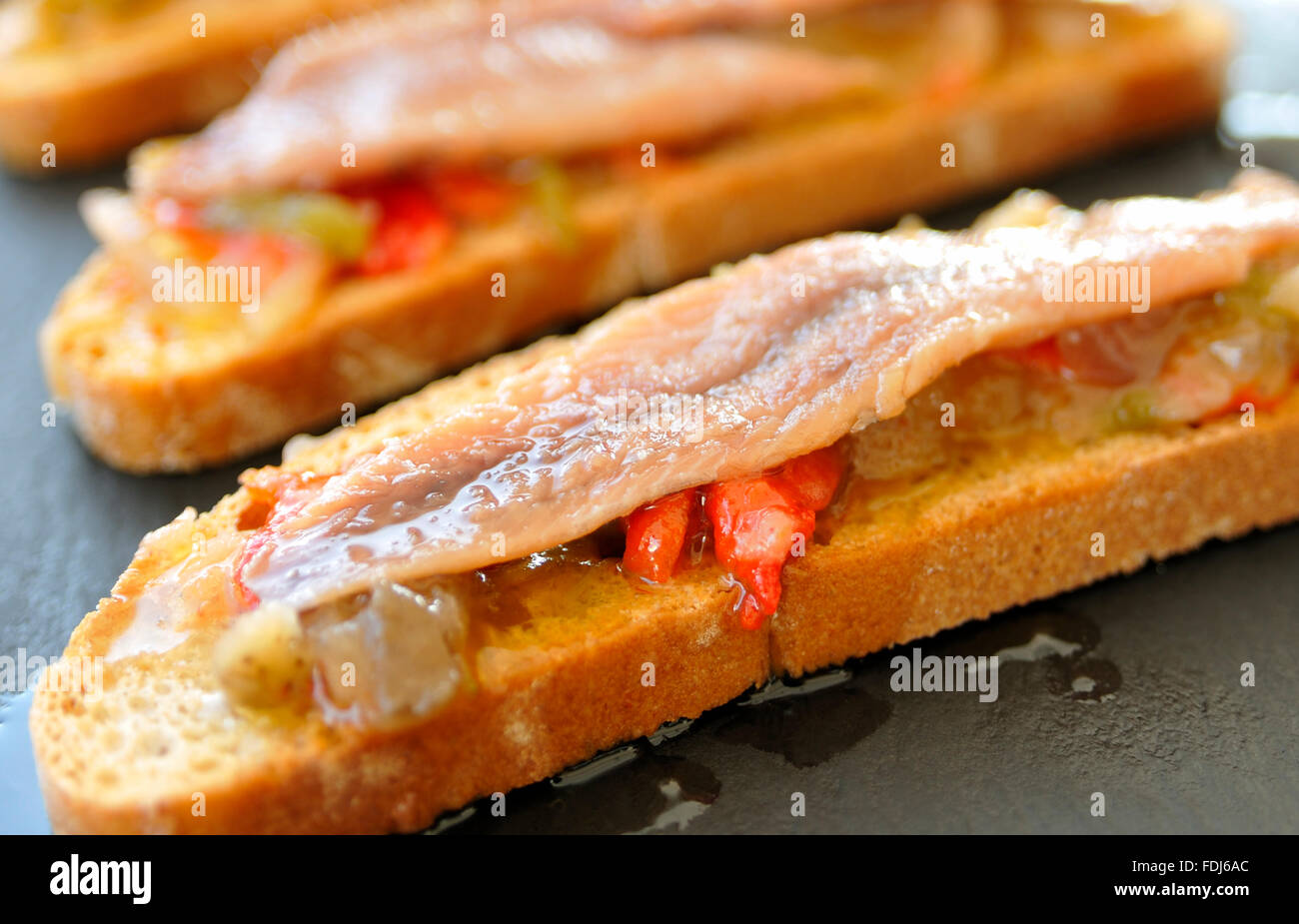 SPANISH CROSTINI STARTER TAPAS Tosta de verdura y anchoa Stock Photo
