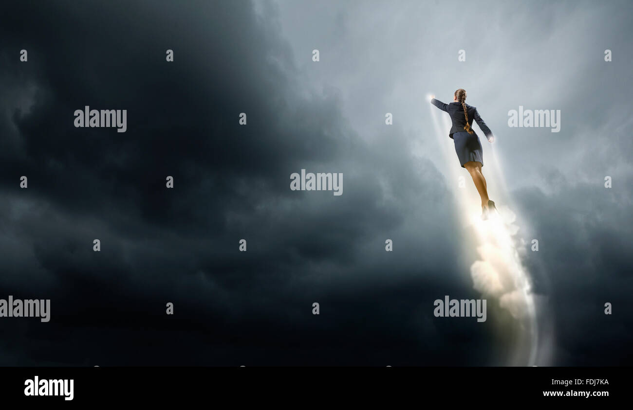 Businesswoman hero in suit flying up into sky Stock Photo - Alamy