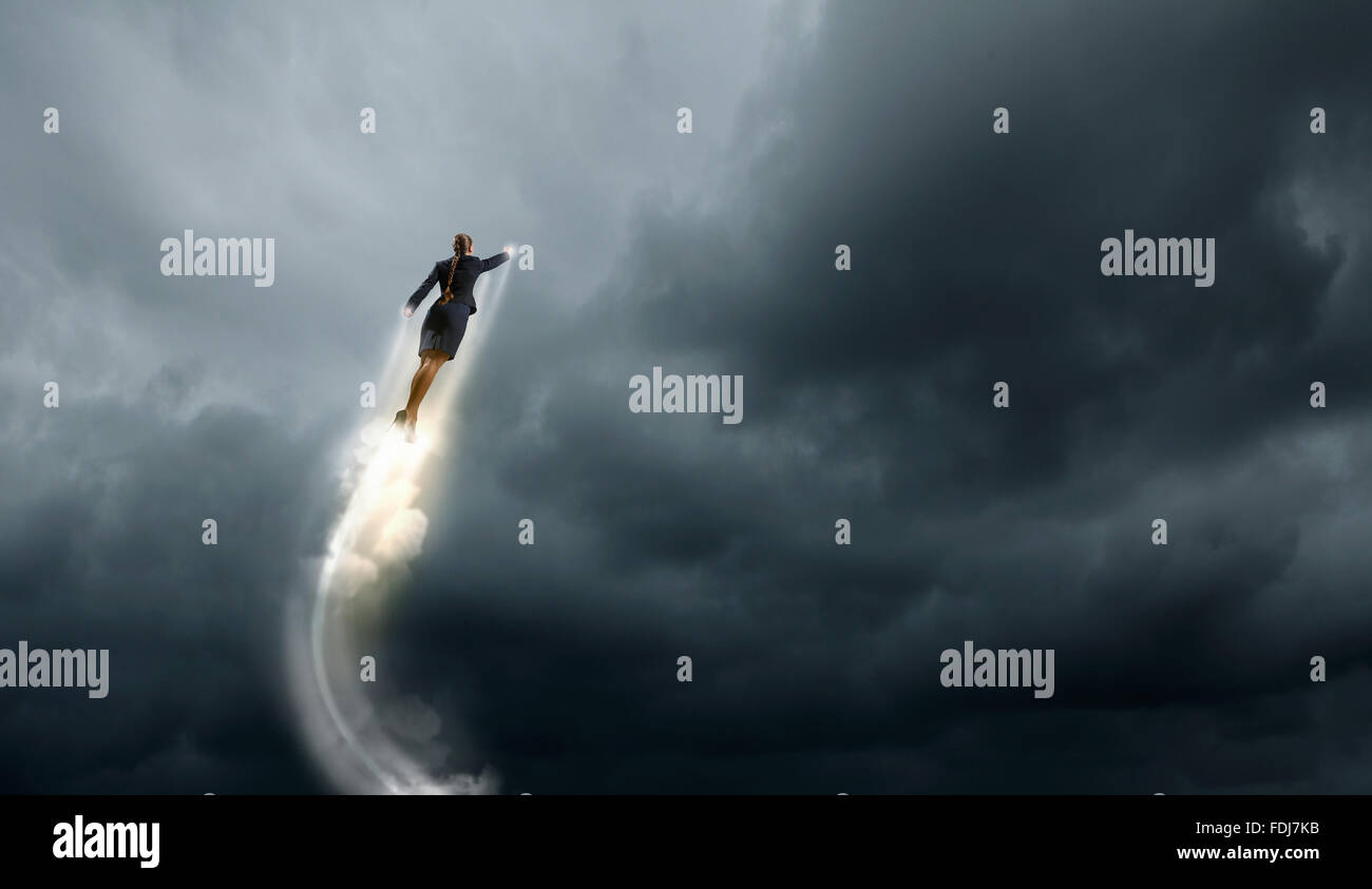 Businesswoman hero in suit flying up into sky Stock Photo - Alamy