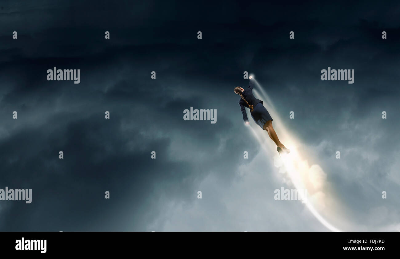 Businesswoman hero in suit flying up into sky Stock Photo - Alamy
