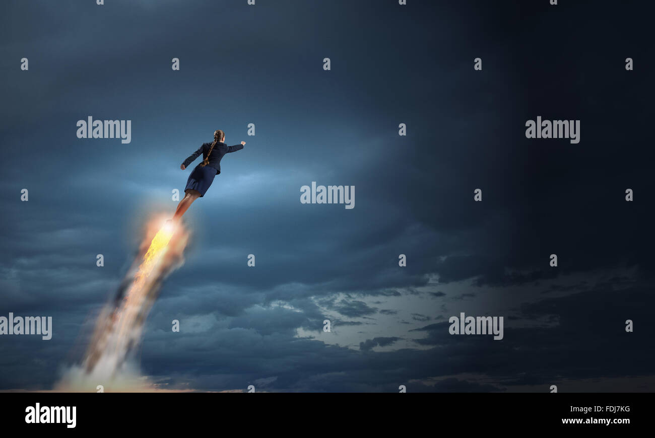 Businesswoman hero in suit flying up into sky Stock Photo - Alamy
