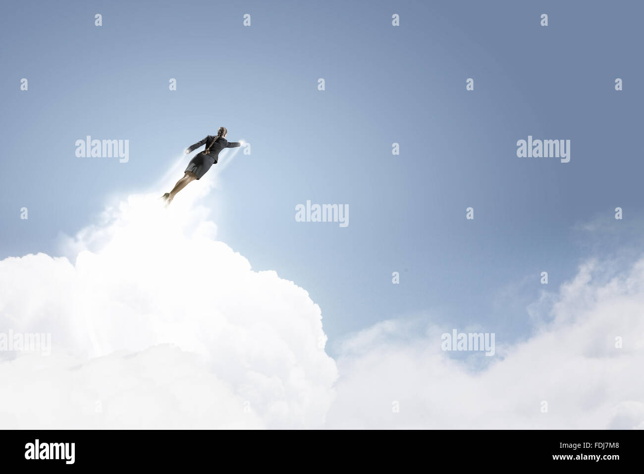 Businesswoman hero in suit flying up into sky Stock Photo - Alamy