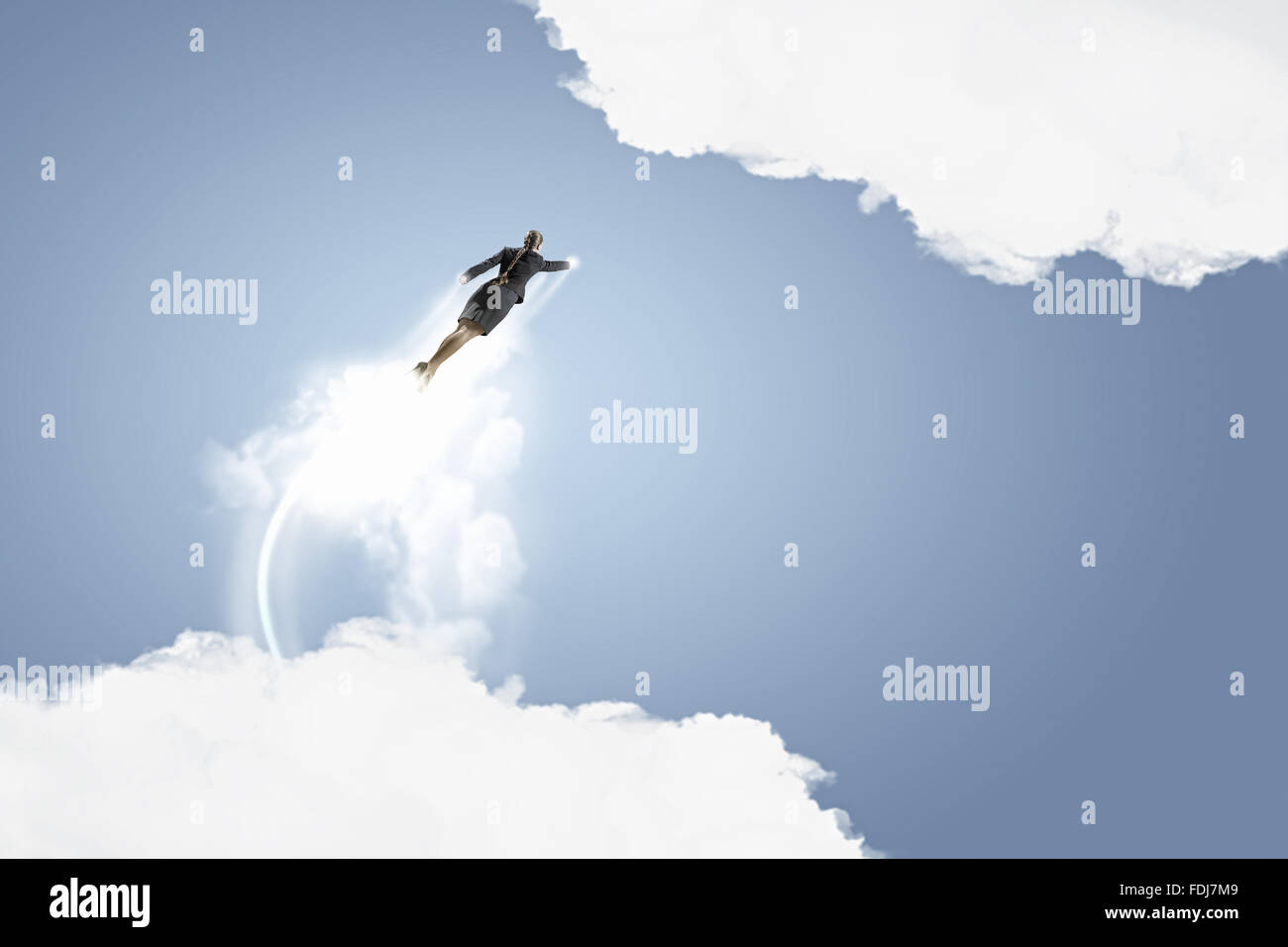 Businesswoman hero in suit flying up into sky Stock Photo - Alamy