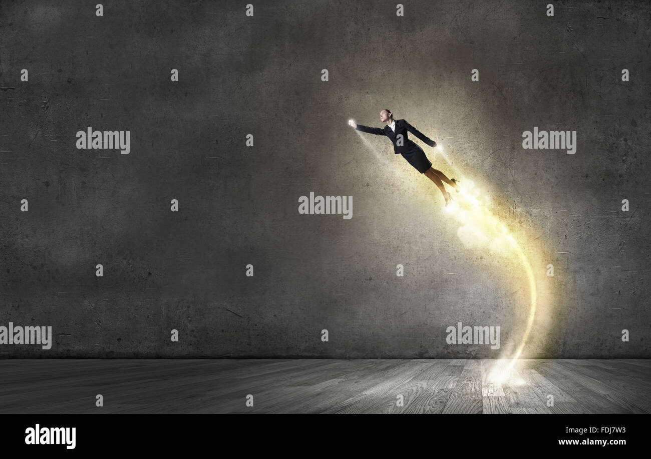 Businesswoman hero in suit flying up into sky Stock Photo - Alamy