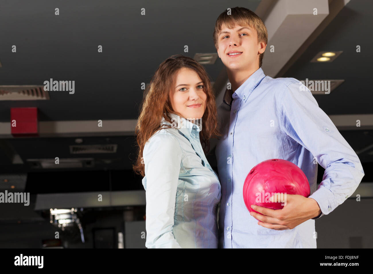 Young couple in bowling club having fun together Stock Photo