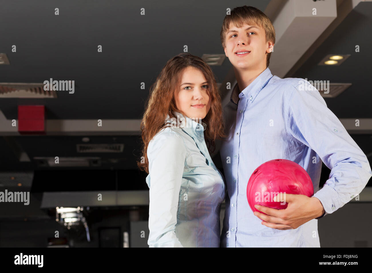 Young couple in bowling club having fun together Stock Photo