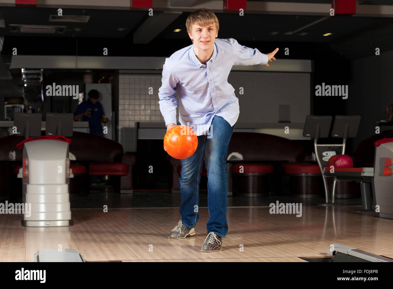 Young guy at bowling club throwing ball Stock Photo Alamy