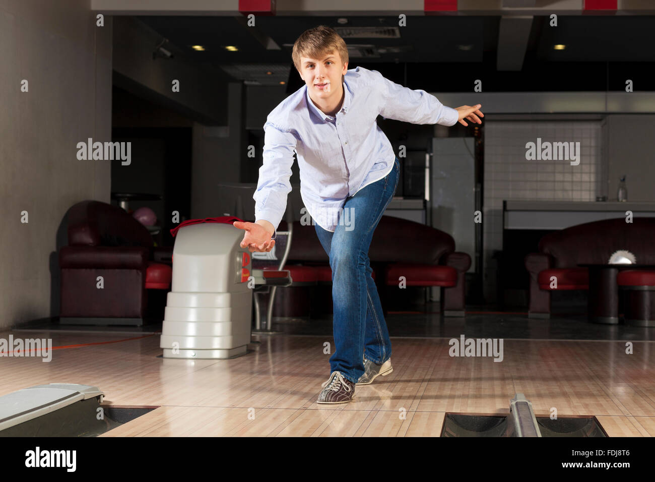 Young guy at bowling club throwing ball Stock Photo Alamy