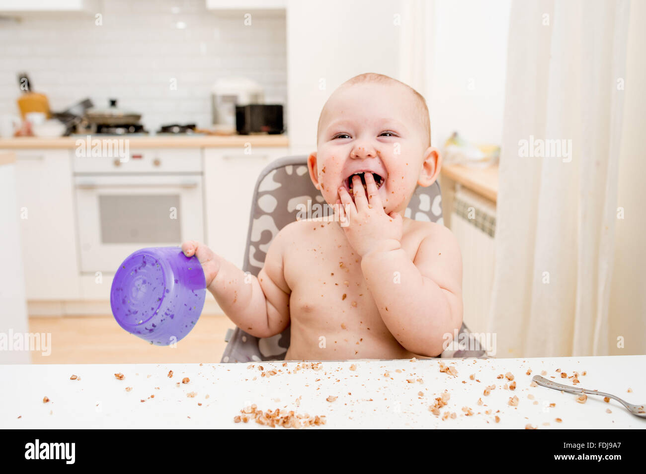 Little baby eating. Happy messy eater Stock Photo Alamy