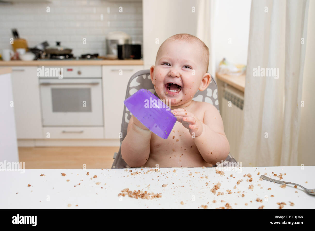 Little baby eating. Happy messy eater Stock Photo Alamy