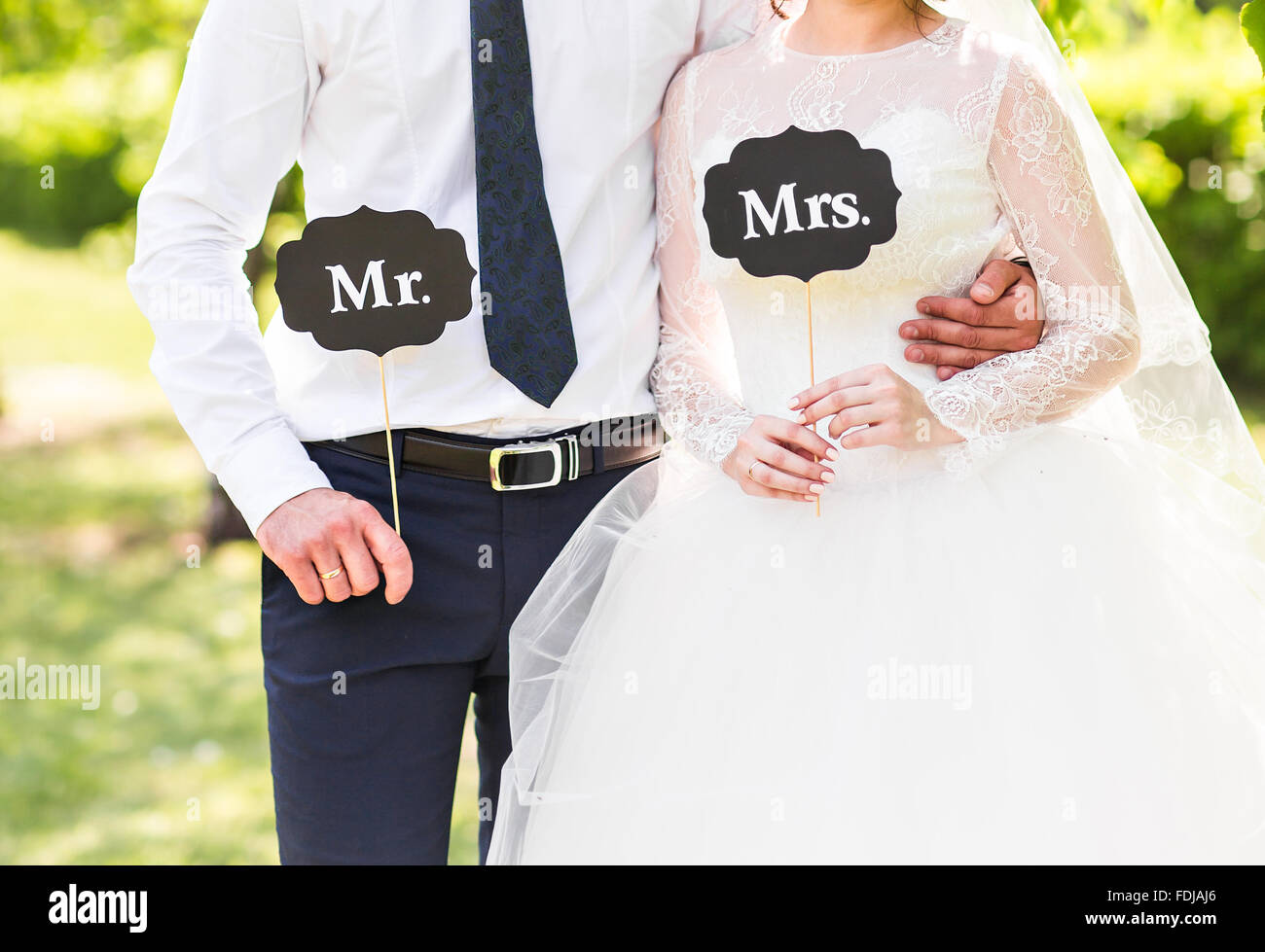 Funny bride and groom with Mr and Mrs signs. Happy wedding day Stock Photo  - Alamy