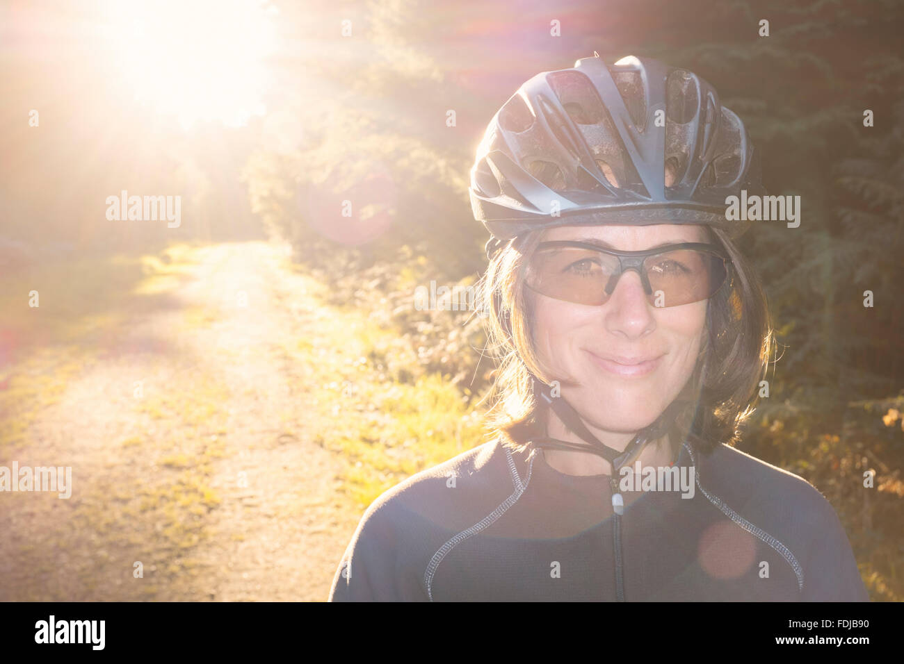 Female mountain biker in the forest. Stock Photo