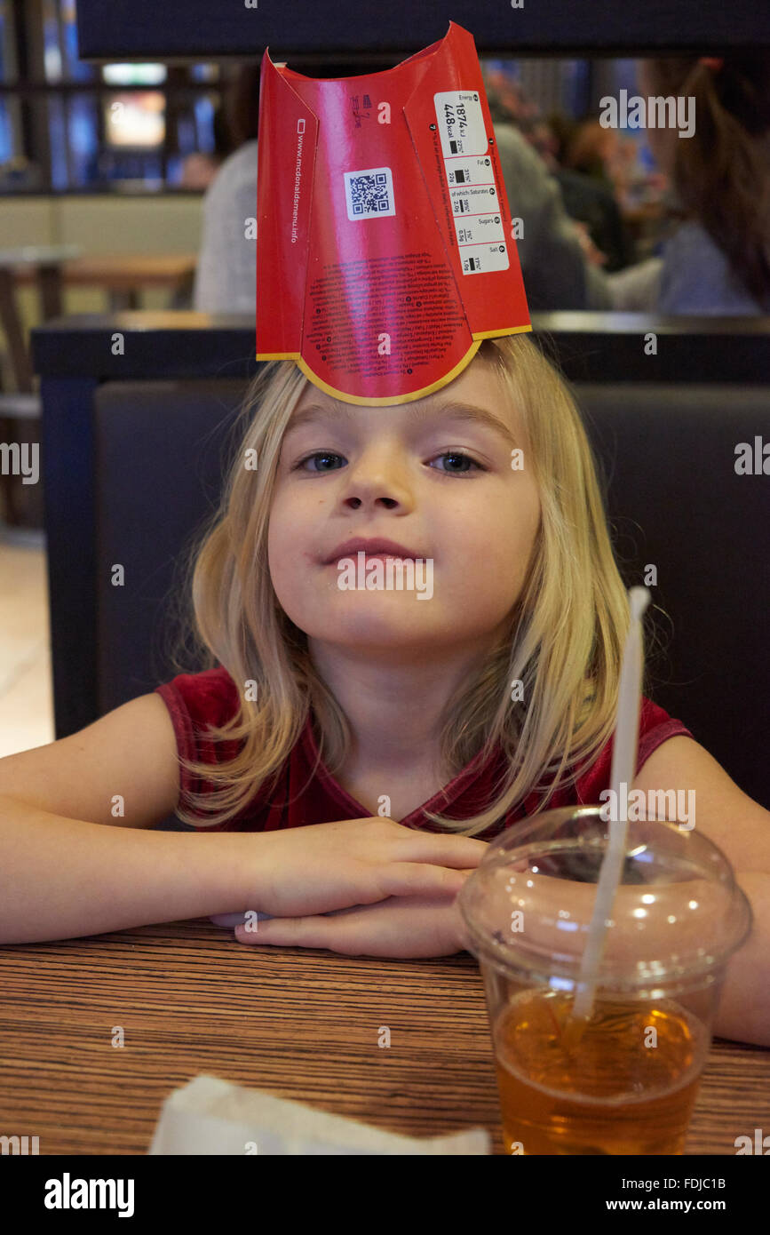 Adorable girl have meal in fast food restaurant Stock Photo