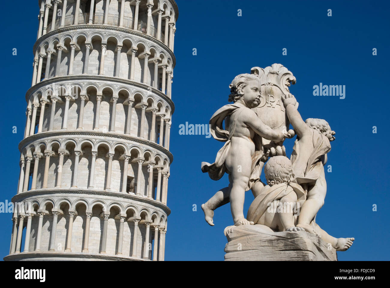 Pisa, Italy. The Leaning Tower with a statue in foreground Stock Photo