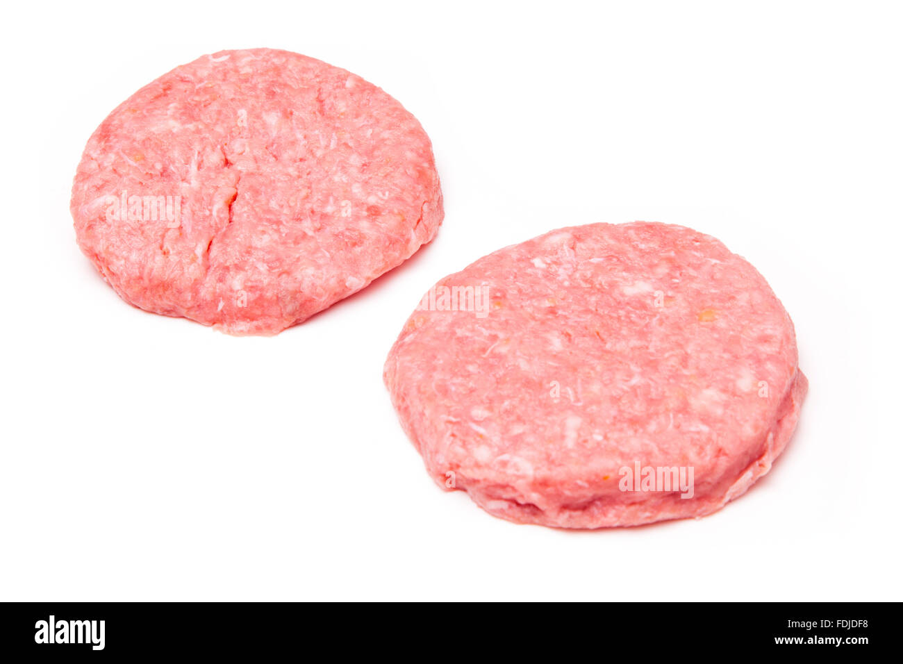 Raw crocodile meat burgers isolated on a white studio background. Stock Photo
