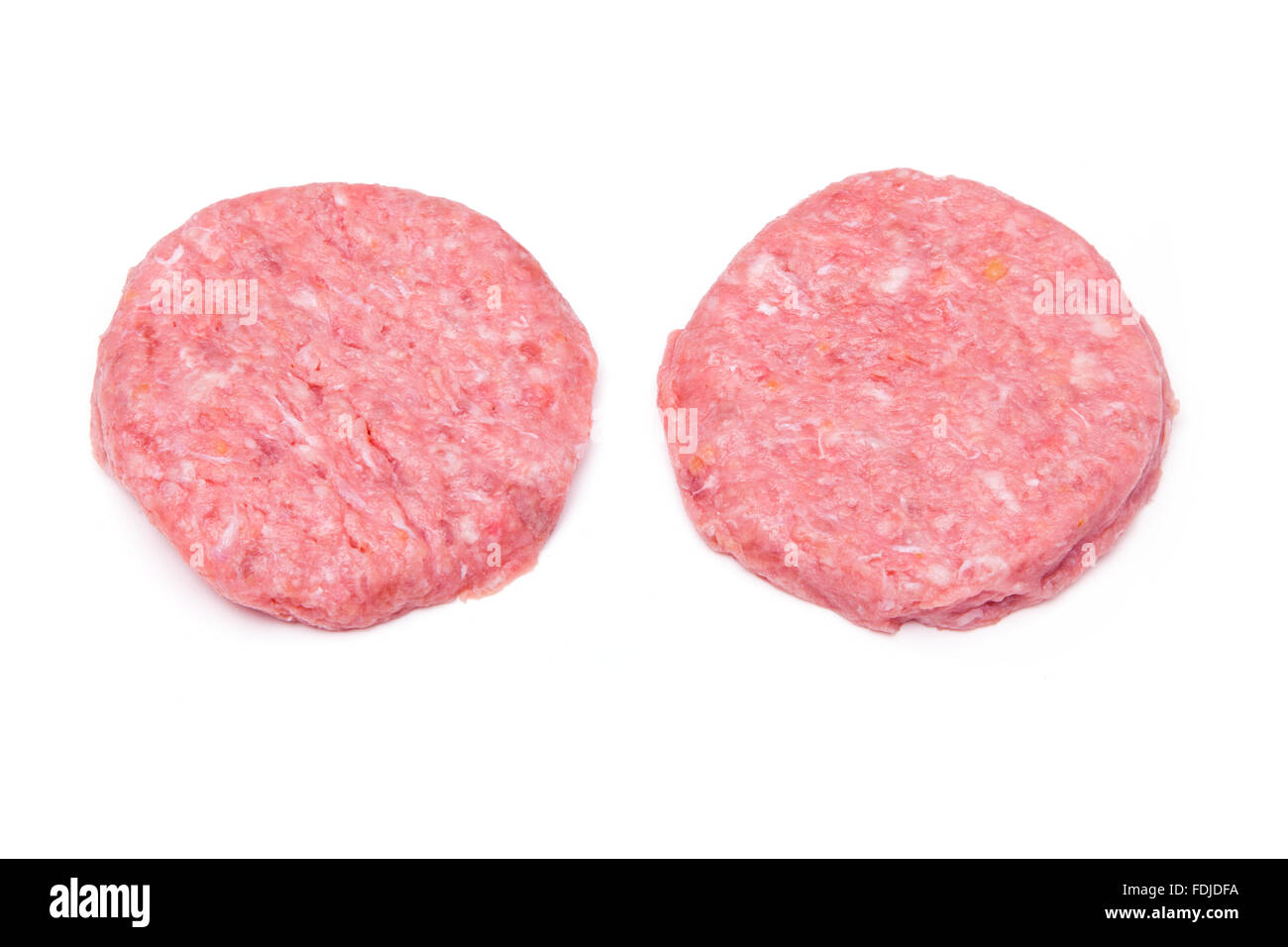 Raw crocodile meat burgers isolated on a white studio background. Stock Photo