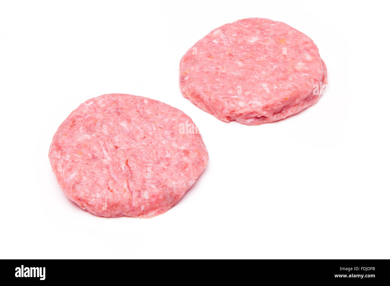 Raw crocodile meat burgers isolated on a white studio background. Stock Photo