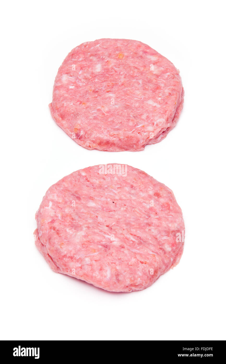 Raw crocodile meat burgers isolated on a white studio background. Stock Photo
