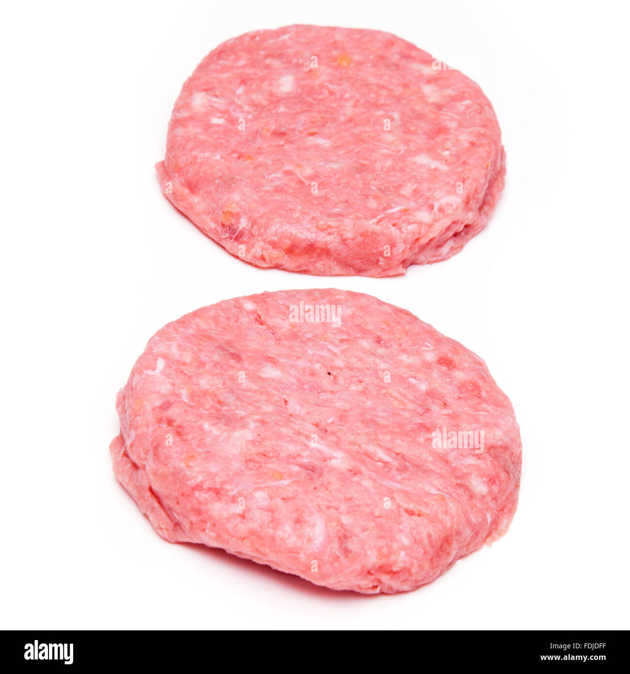 Raw crocodile meat burgers isolated on a white studio background. Stock Photo