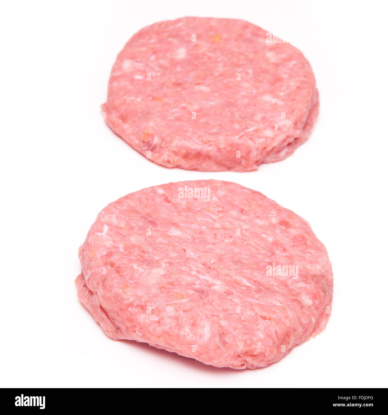 Raw crocodile meat burgers isolated on a white studio background. Stock Photo