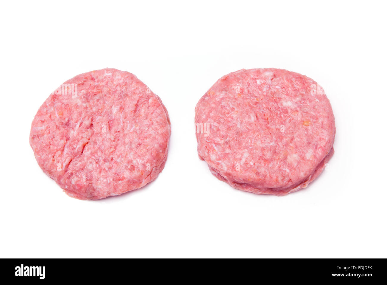 Raw crocodile meat burgers isolated on a white studio background. Stock Photo