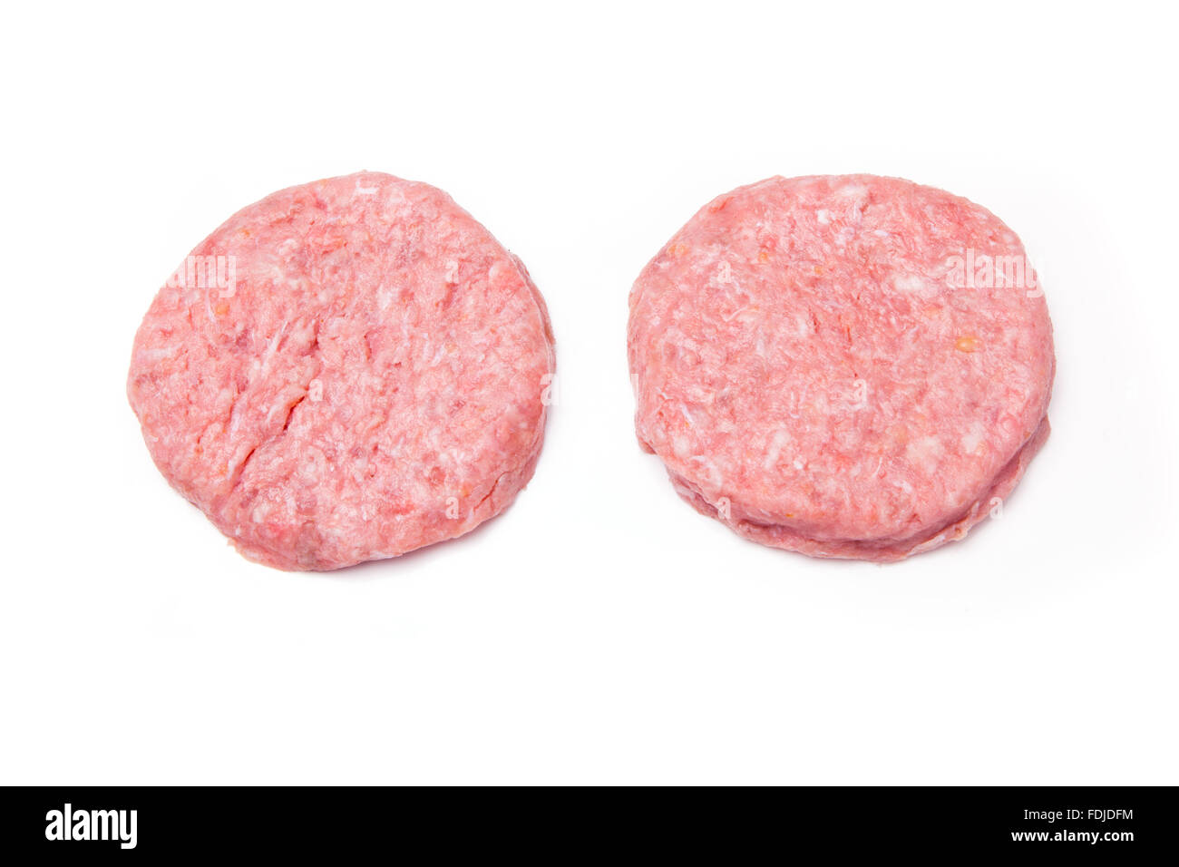 Raw crocodile meat burgers isolated on a white studio background. Stock Photo