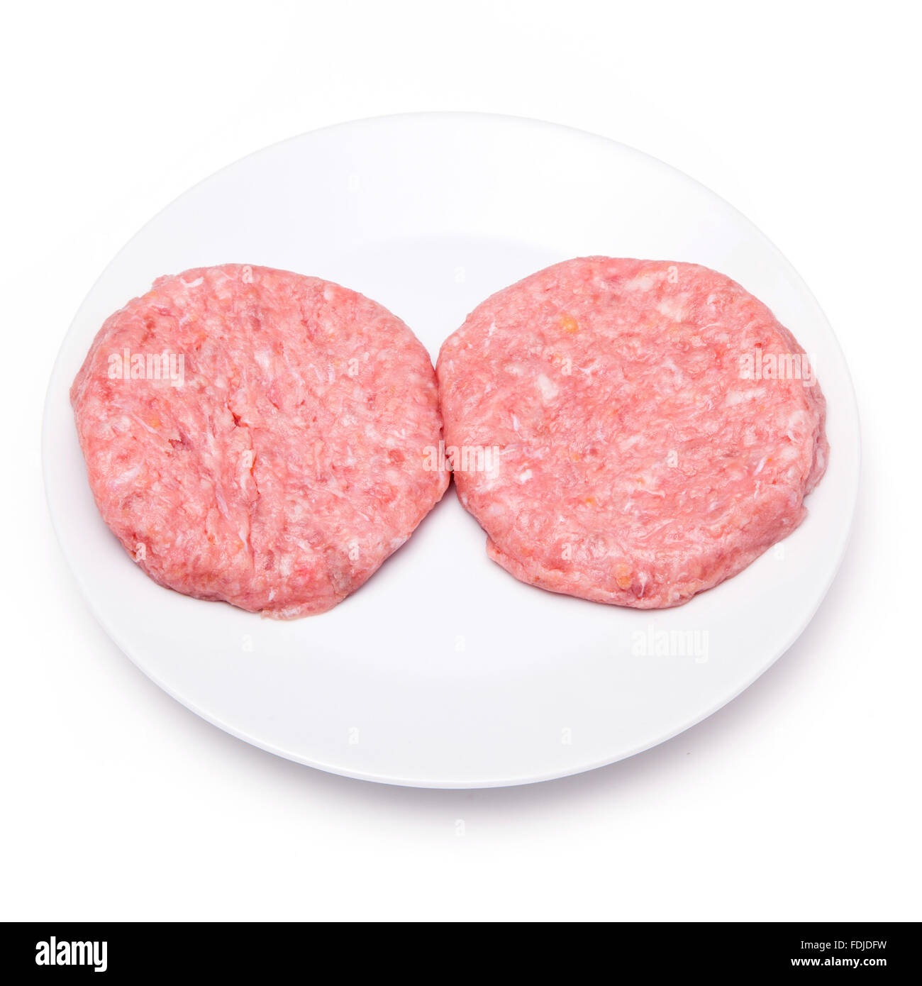 Raw crocodile meat burgers isolated on a white studio background. Stock Photo