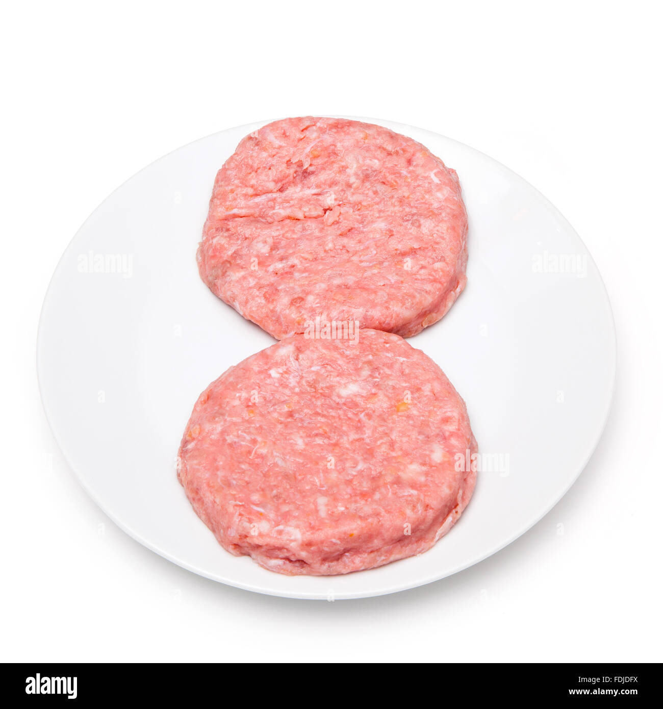Raw crocodile meat burgers isolated on a white studio background. Stock Photo
